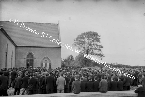 MEN AT CLOSING SERMON OUTSIDE THE CHURCH